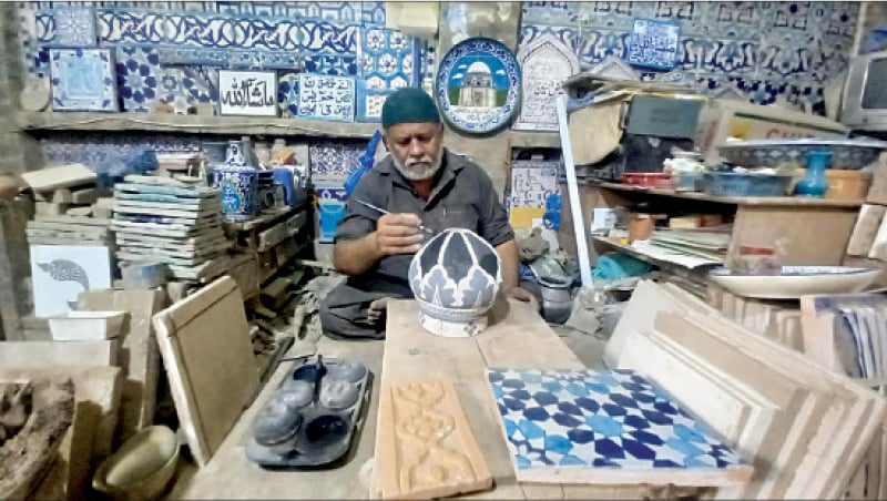 Ustad Muhammad Wajid Kashigar painting a ceramic dome in his Multan workshop